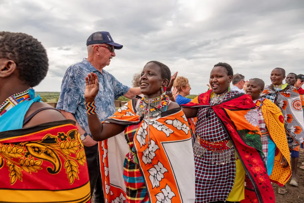 An AOL traveler greets women in the maasai village during the maasai cultural immersion